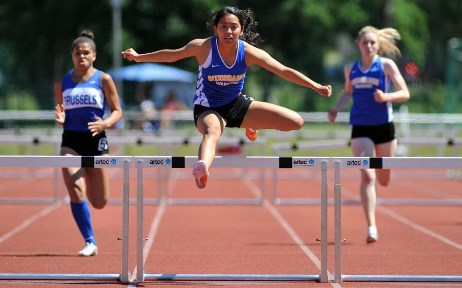 Wiesbaden's Clarissa Paniagua takes the last hurdle, on her way to winning the 300-meter hurdles race at the DODEA-Europe track and field finals in Kaiserslautern, Germany, Saturday, May 27, 2017. Her winning time was 46.67 seconds. At left is Evin Harper of Brussels, at right Wiesbaden's Brigantia O'Sadnick, who finished second and third.