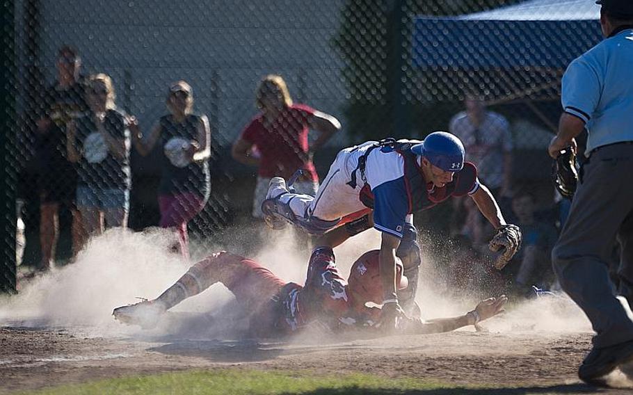 Lakenheath's Kaiden Morales, left, slides into home and Ramstein's Aaron Scholsser during the DODEA-Europe Division I baseball championship at Ramstein Air Base, Germany, on Saturday, May 27, 2017. Lakenheath lost the game 8-6.

MICHAEL B. KELLER/STARS AND STRIPES