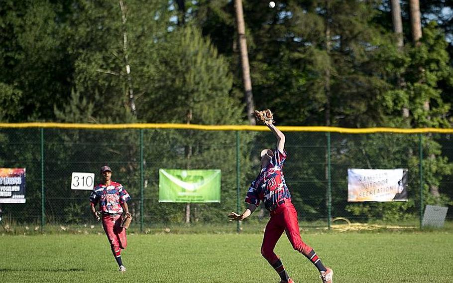 Lakenheath's Michael Nighbert, right, catches a fly ball as Jordan Harris moves in to assist during the DODEA-Europe Division I baseball championship at Ramstein Air Base, Germany, on Saturday, May 27, 2017. Lakenheath lost the game against Ramstein 8-6.

MICHAEL B. KELLER/STARS AND STRIPES