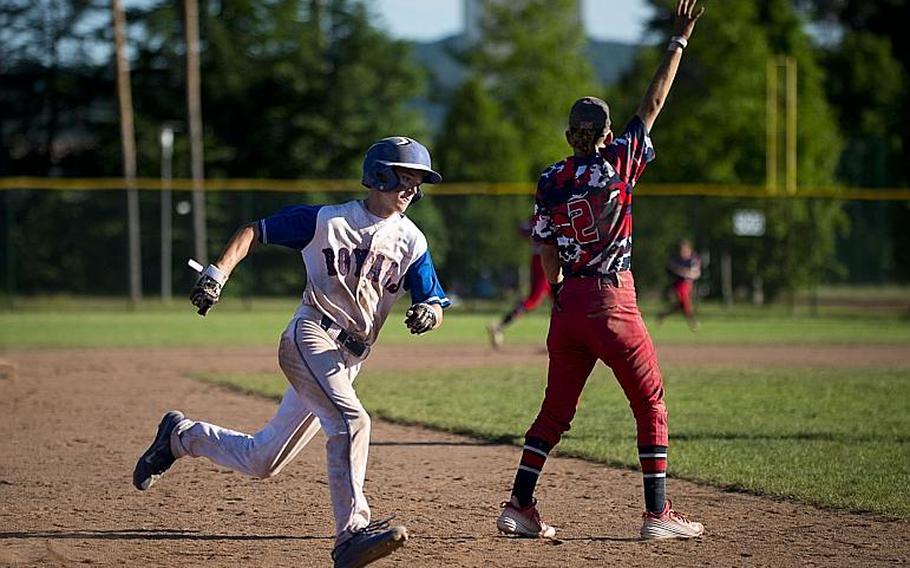 Ramstein's Reed Marshall rounds third behind Lakenheath's Kaiden Morales during the DODEA-Europe Division I baseball championship at Ramstein Air Base, Germany, on Saturday, May 27, 2017. Ramstein won the game 8-6.

MICHAEL B. KELLER/STARS AND STRIPES