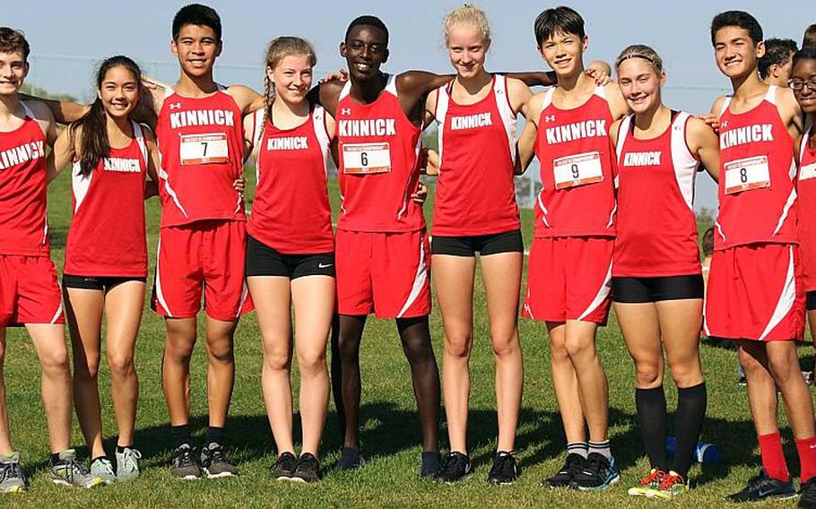 A Red Devil of a repeat. Nile C. Kinnick's cross country team arm in arm after capturing its second straight Far East cross-country Division I overall school banner, the second time in 10 years.