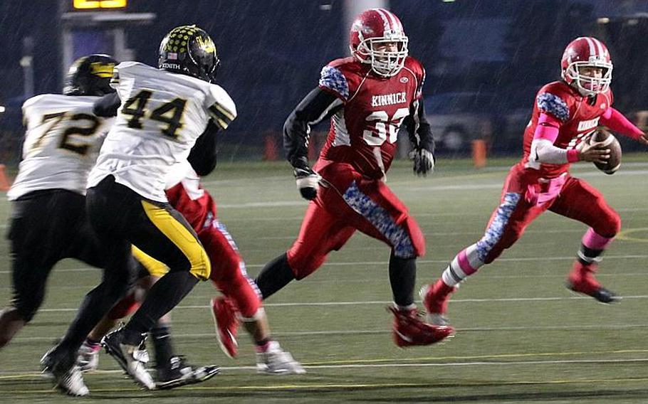 Nile C. Kinnick quarterback Kacey Walker rolls right to avoid the Kadena defense.