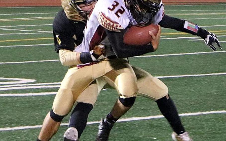 Matthew C. Perry running back Andrew Borrero is wrapped up by Humphreys' Owen Williams.