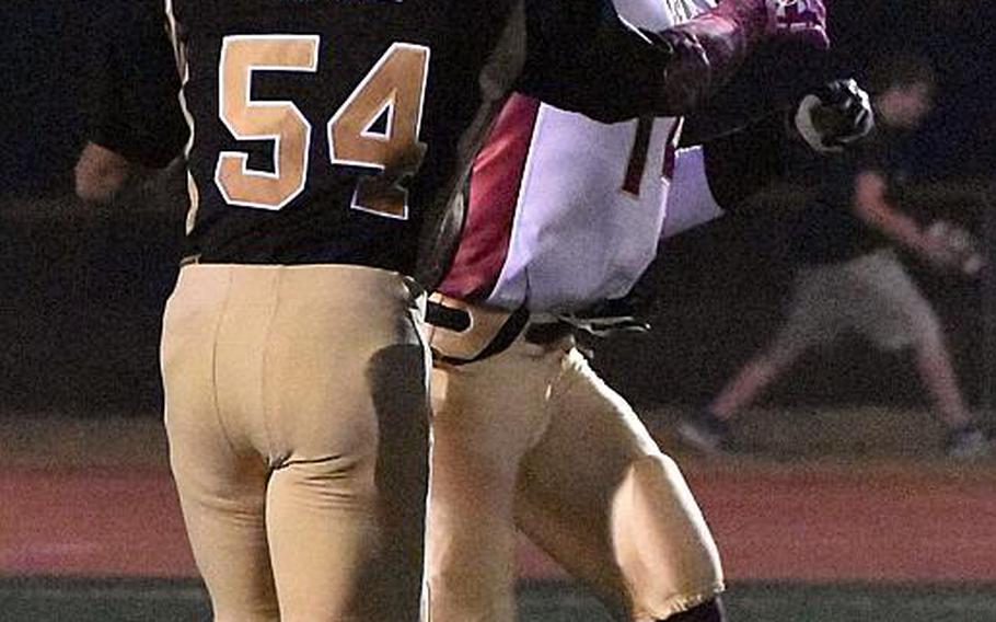 Matthew C. Perry quarterback Garrett Macias unloads the ball as Humphreys' defender Joel Tinsley approaches.