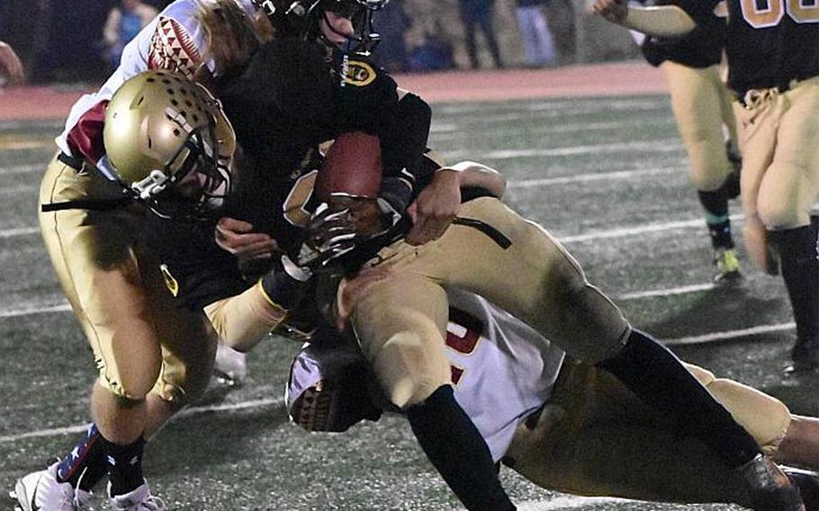 Humphreys receiver Owen Williams gets wrapped up by Matthew C. Perry defenders Eli Perez and Matthew Torrecillias.