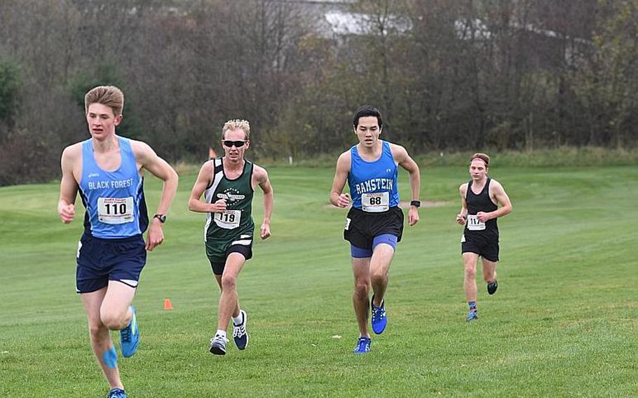 Naples' Daniel Aleksandersen, Ramstein's Jose Serrano, and Stuttgart's Paul Fullwood were in hot pursuit of frontrunner and eventual winner Mac Roberts of Black Forest Academy during the DODEA European cross country championships on Saturday, Oct. 28, 2017, in Baumholder, Germany.