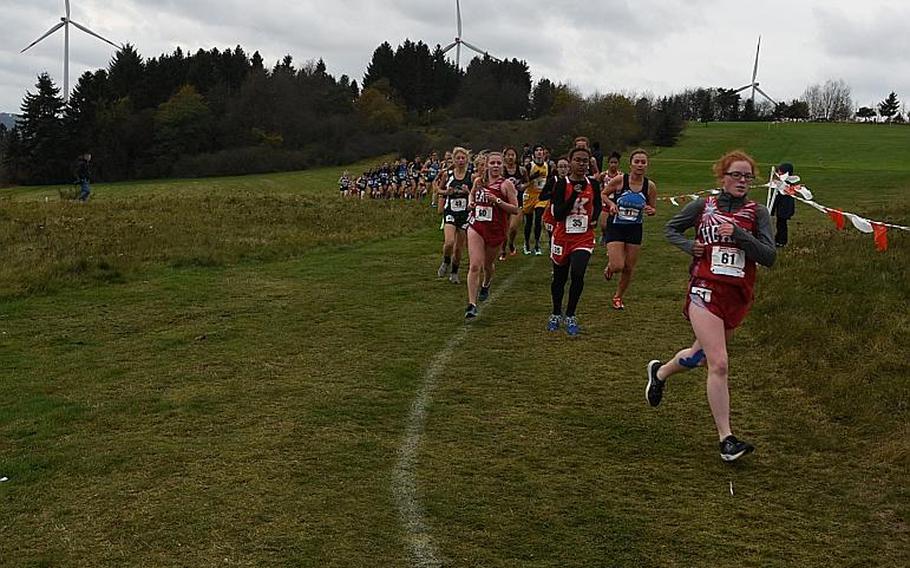 Runners spread out as they race down a hill and around a bend at the Rolling Hills Golf Course in Baumholder, Germany, on Saturday, Oct. 28, 2017. The wind and cold made race conditions challenging at the DODEA European cross country championships.