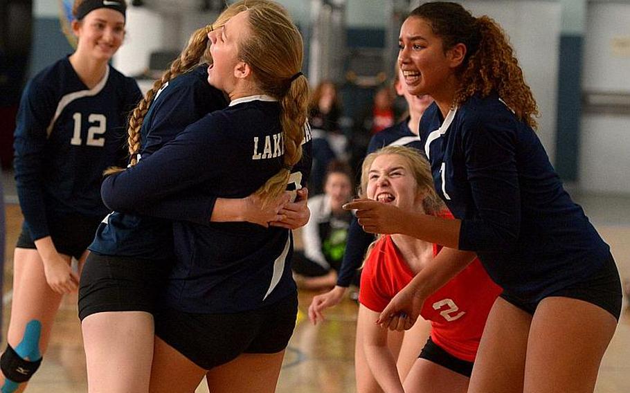 The Lakenheath Lancers celebrate their penultimate point on their way to beating Stuttgart 25-23, 25-23, 25-20 in the Division I title game at the DODEA-Europe volleyball finals in Kaiserslautern, Germany, Saturday, Nov.4, 2017.