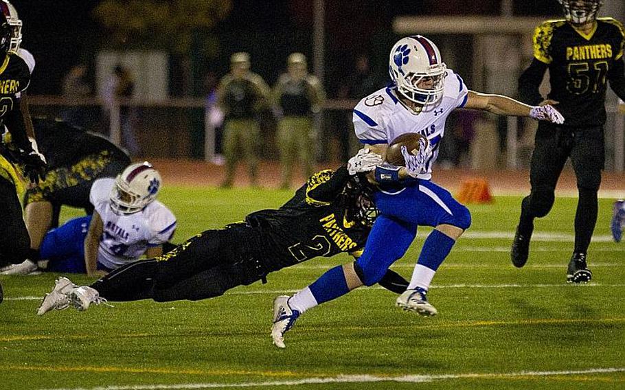 Ramstein's Bailey Holland, right, breaks a tackle by Stuttgart's Will Tonder at Vogelweh, Germany, on Saturday, Nov. 4, 2017.