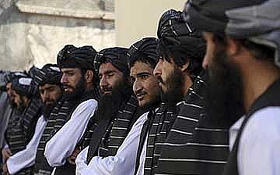 Afghan prisoners line up after their release from Pul-e-Charkhi prison, in Kabul, Afghanistan, Thursday, Jan. 11, 2018. The Afghan president pardoned 75 prisoners loyal to Gulbuddin Hekmatyar, a former warlord and U.S.-declared terrorist who signed a peace agreement with Kabul in 2016. The deal gave Hekmatyar and his followers immunity for past actions and granted them full political rights.