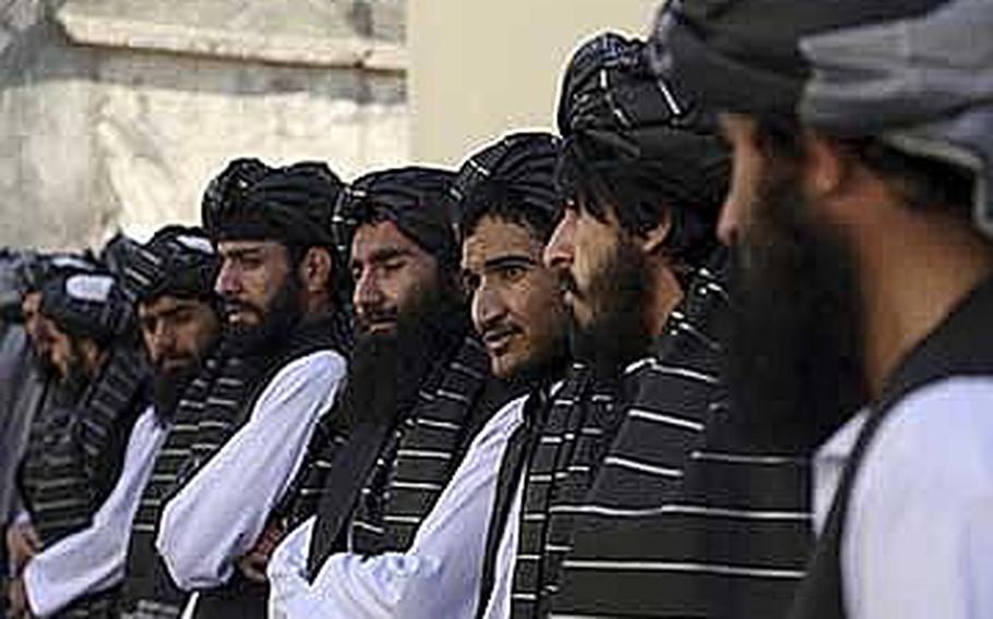 Afghan prisoners line up after their release from Pul-e-Charkhi prison, in Kabul, Afghanistan, Thursday, Jan. 11, 2018. The Afghan president pardoned 75 prisoners loyal to Gulbuddin Hekmatyar, a former warlord and U.S.-declared terrorist who signed a peace agreement with Kabul in 2016. The deal gave Hekmatyar and his followers immunity for past actions and granted them full political rights. 