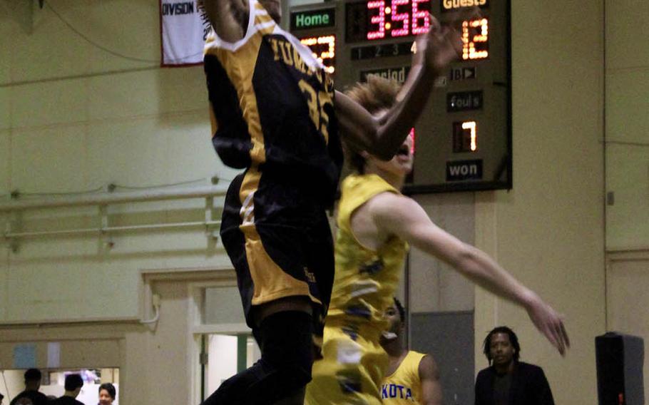 Humphreys' Jalen Hill goes up for a slam dunk against Yokota during Tuesday's final in the Far East Boys Division II Basketball Tournament. The Blackhawks beat Yokota 74-46 for their first D-II basketball title.