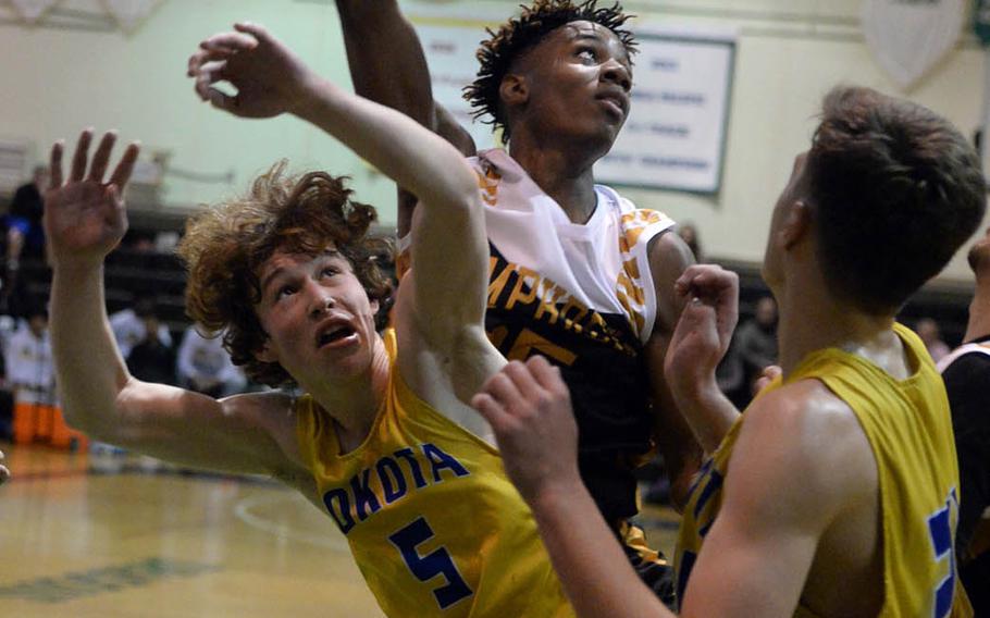 Humphreys' Jalen Hill can't find the handle on the ball against Yokota's Ethan Gaume during Tuesday's final in the Far East Boys Division II Basketball Tournament. The Blackhawks beat Yokota 74-46 for their first D-II basketball title.