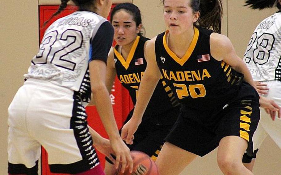 American School of Bangkok's Keisharna Lucas looks for room against Kadena's Megan Kirby during Thursday's final in the Far East girls combined division basketball tournament. The Eagles edged the Panthers 47-42.