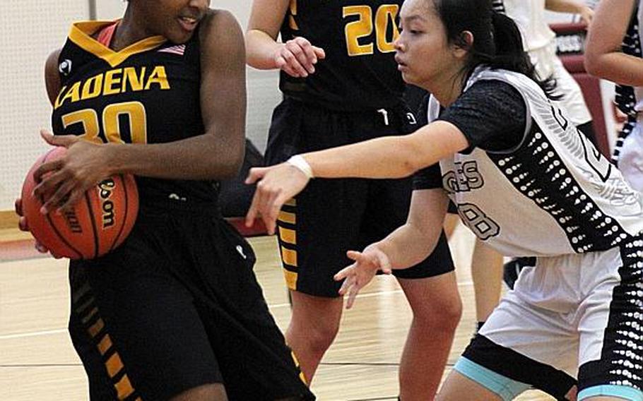 Kadena's Atirria Simms protects the ball against the American School of Bangkok defense during Thursday's final in the Far East girls combined division basketball tournament. The Eagles edged the Panthers 47-42.