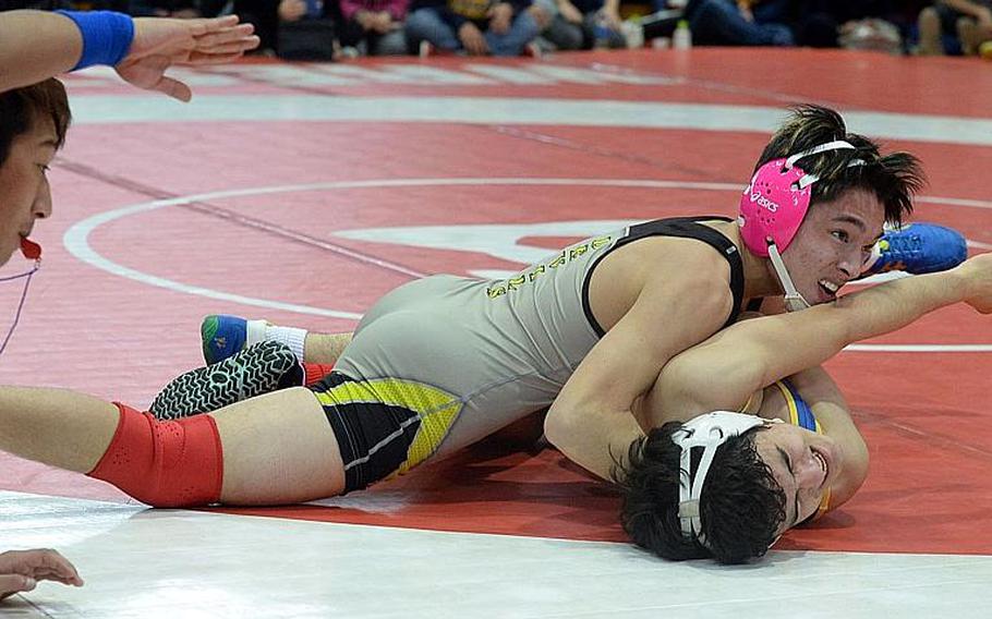 Nile C. Kinnick senior 129-pounder Lucas Wirth puts the finishing touches on his pinfall victory over St. Mary's  Rio Lemkuil during the championship meet of the 41st Far East Wrestling Tournament's Division I dual-meet final. Wirth won in 1 minute, 12 seconds and Kinnick edged St. Mary's 30-28 for the title.