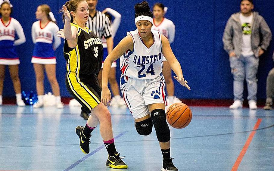 Ramstein's Shemilia Johnson, right, dribbles past Stuttgart's Claire Troiano at Ramstein Air Base, Germany, on Friday, Jan. 12, 2018.