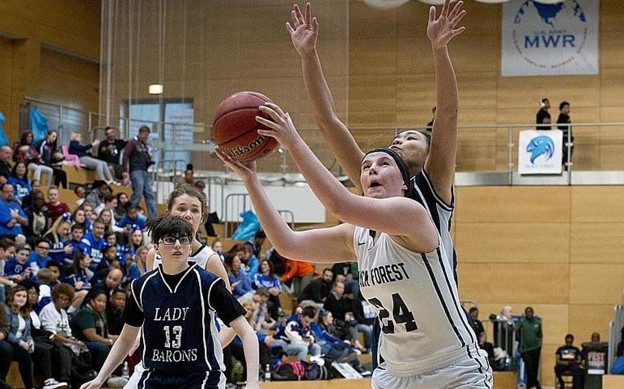 Black Forest Academy's Jessica Campbell gets a rebound in front of Spangdhalem's Justine Tila during the DODEA-Europe Division II championship in Wiesbaden, Germany, on Saturday, Feb. 24, 2018.