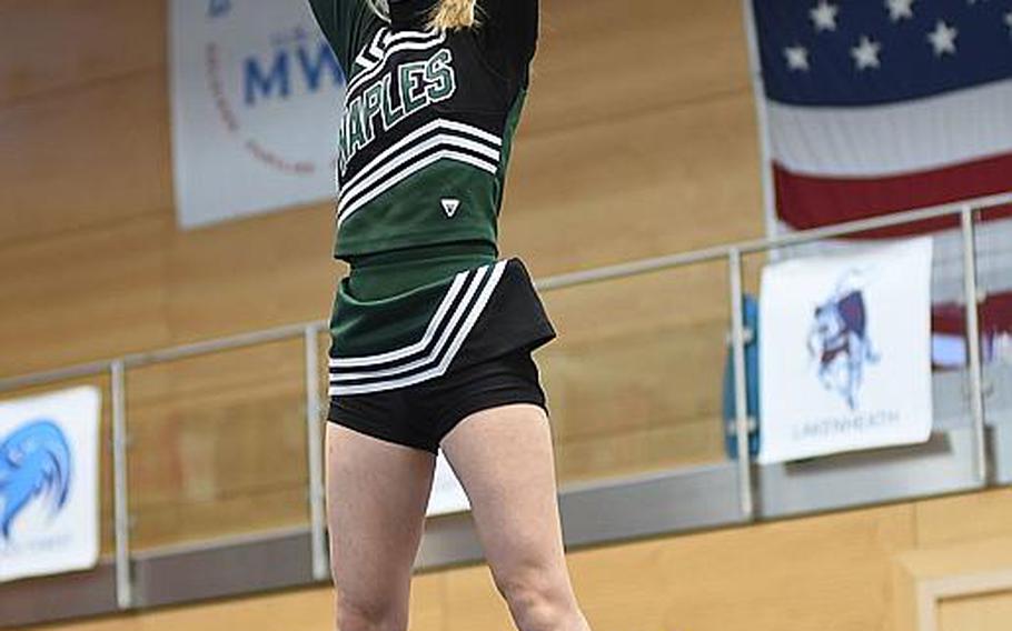 Naples freshman Abby Acheson cheers from up high during the DODEA-Europe cheer tournament on Saturday, Feb. 24, 2018, in Wiesbaden, Germany.