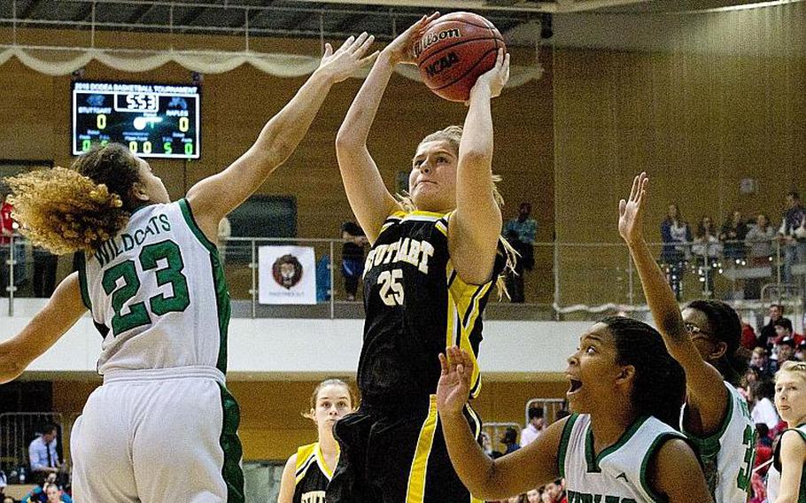 Stuttgart's Allyson Taylor takes a jump shot over Naples' Jada Williamson, left, and Mia Rawlins during the DODEA-Europe Division I championship in Wiesbaden, Germany, on Saturday, Feb. 24, 2018. Stuttgart won 31-25.