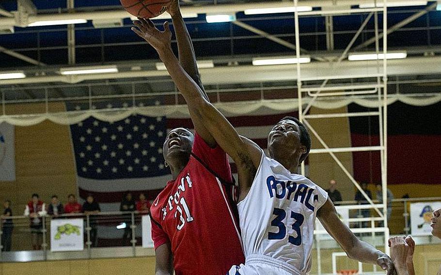 Kaiserslautern's Jovaine Ebanks, left, and Ramstein's Sincere Dudley jump for a rebound during the DODEA-Europe Division I championship in Wiesbaden, Germany, on Saturday, Feb. 24, 2018.