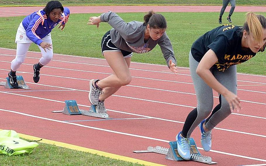 Kadena hurdlers, from left, Rhamsey Wyche, Sofia Strawder and Crystal Scott charge out of the starting blocks.