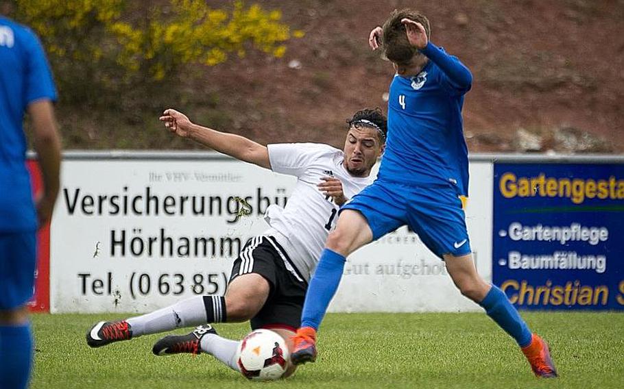 Vicenza's Christopher Ortiz, left, slides to challenge Ramstein's Gavin McMillan during the DODEA-Europe soccer tournament in Reichenbach, Germany, on Thursday, May 18, 2017. Ramstein and Vicenza tied the Division I match 1-1 and Ramstein advanced to the semifinals.