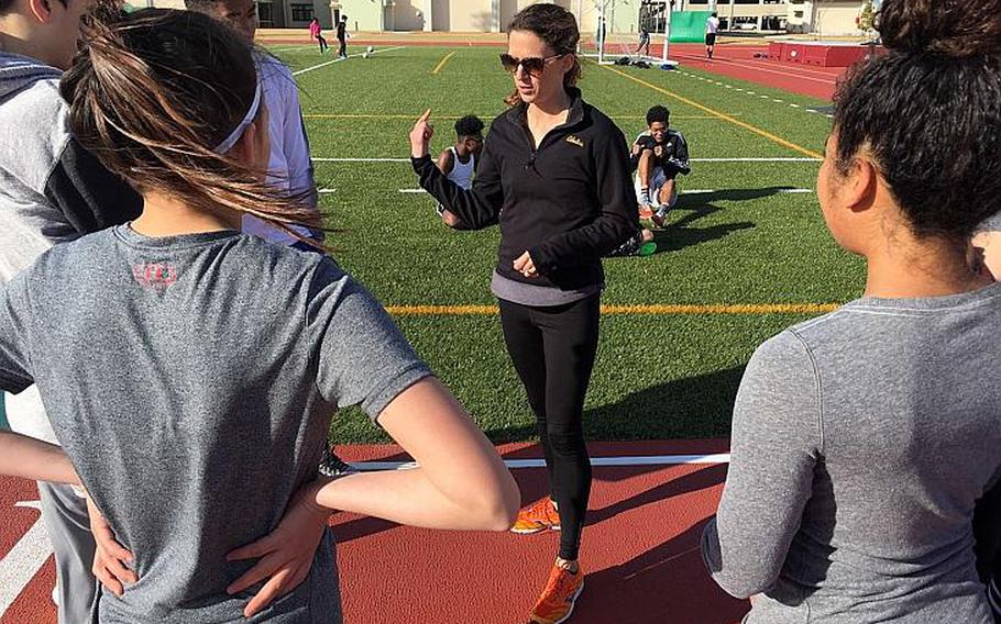 Matthew C. Perry coach Anna Simmermon goes through instructions with her charges during a break in practice.