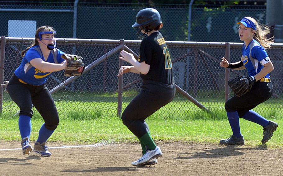 Eagle in a pickle. Robert D. Edgren's Caitlin Haydam finds herself caught between Yokota infielders Katie Lambie and Madison Derber during Saturday's DODEA Japan softball tournament final. The Eagles rallied past the Panthers 13-12 for their first title in this tournament's history.