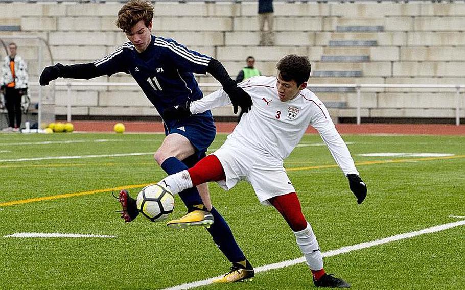 Black Forest Academy's Jurian Van den Berg, left, and Kaiserslautern's Conner Mackie battle for the ball in Kaiserslautern, Germany, on Saturday, March 17, 2018.