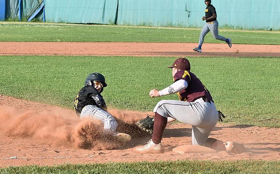 Vicenza's Jesse Samsel created a nice cloud of dust while sliding into third base, but Vilseck's Jordan Leighty tags him out in the Falcons' 6-3 victory on Friday, April 27, 2018.