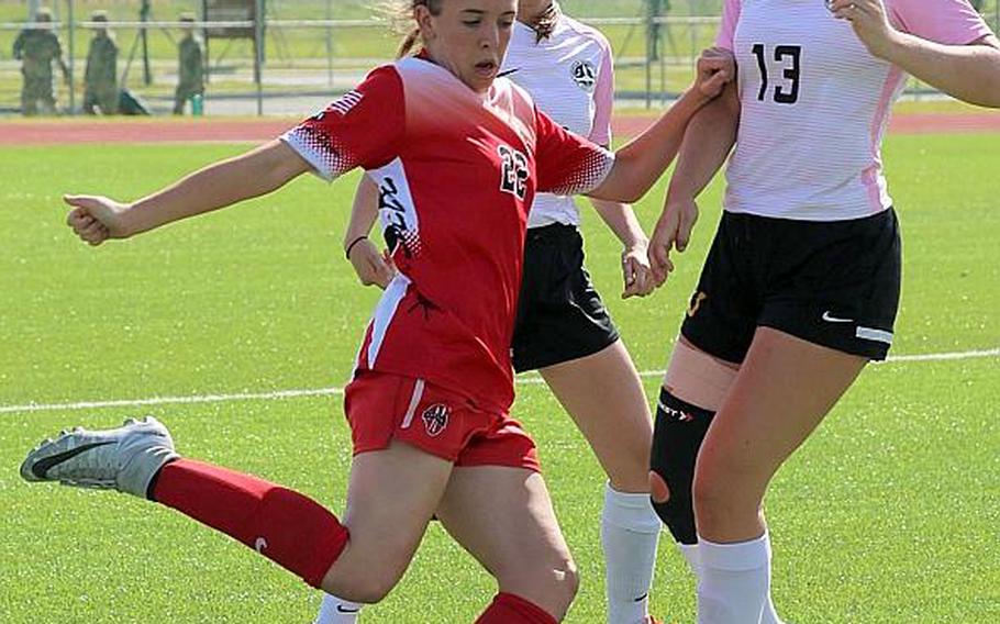 Nile C. Kinnick's Maggie Donnelly tries to clear the ball away from American School In Japan defenders during Wednesday's championship match in the Far East Division I girls soccer tournament. The Mustangs dethroned the defending champion Red Devils 5-3.