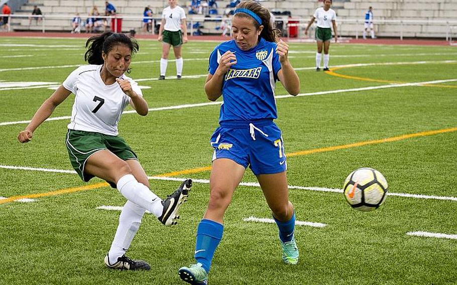 Alconbury's Victoria Flores, left, passes the ball around Sigonella's Emmy McCarthy during the DODEA-Europe Division III soccer championship in Kaiserslautern, Germany, on Thursday, May 24, 2018.