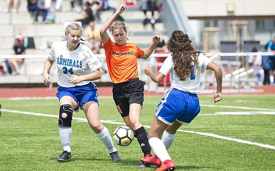 Spangdhalem's Ava Bohn dribbles between Rota's Jacqueline Holtz, left, and Erika Lathem during the DODEA-Europe Division II soccer championship in Kaiserslautern, Germany, on Thursday, May 24, 2018. Spangdhalem won the game 2-0.