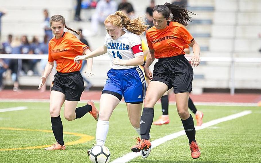 Rota's Emma Hook dribbles between Spangdhalem's Tahlia Mower-Scheid, left, and Emelia Lenz during the DODEA-Europe Division II soccer championship in Kaiserslautern, Germany, on Thursday, May 24, 2018.