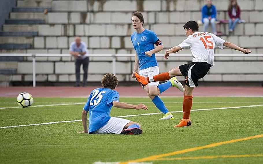 AFNORTH's Victor Soriano takes a shot between Marymount's Tomas Lopes, left, and Alexander Klarenbeek for a goal during the DODEA-Europe Division II soccer championship in Kaiserslautern, Germany, on Thursday, May 24, 2018. AFNORTH won the game 2-1.