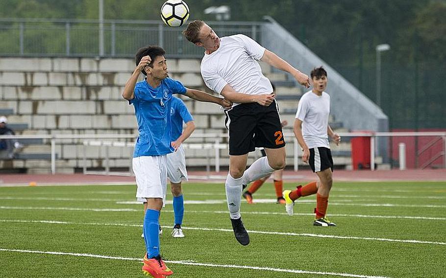 AFNORTH's Seth BonenClark, right, and Marymount's Chan Sol Park jump for a header during the DODEA-Europe Division II soccer championship in Kaiserslautern, Germany, on Thursday, May 24, 2018.