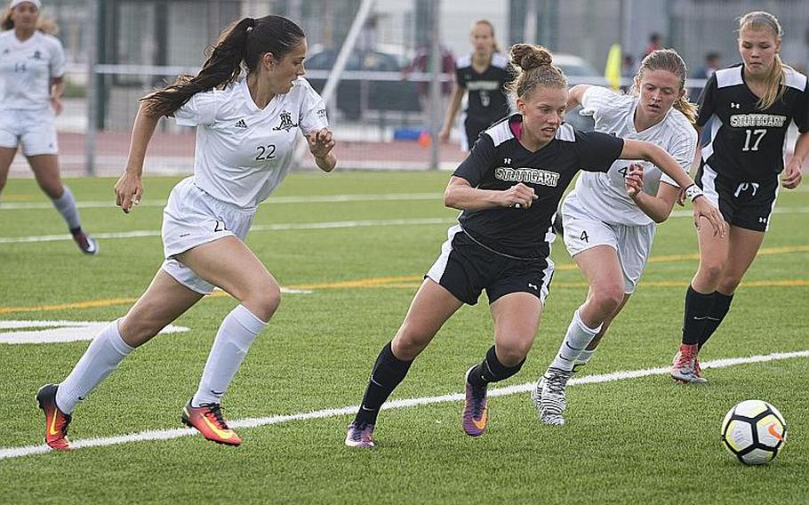 Stuttgart's Adan Maher cuts between Ramstein's Rocio Fernandez, left, and Brittany Cunningham during the DODEA-Europe Division I soccer championship in Kaiserslautern, Germany, on Thursday, May 24, 2018. Stuttgart won the game 6-5 after a shootout.
