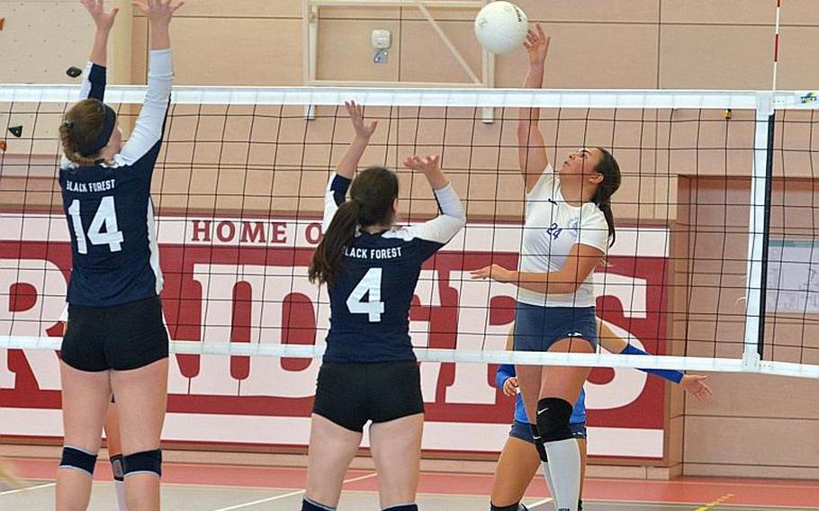 Marymount's Emanuela Scalia hits the ball against Black Forest Academy's Jessie Campbell, left, and Kennedy Wilbanks. Marymount took the DODEA-Europe Division II volleyball title with a 24-26, 25-18, 25-21, 25-13 win.