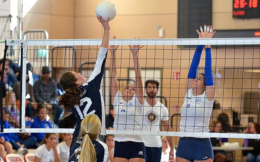 Black Forest Academy's Brianne Maier hits one over the net against the Marymount block of Margherita Guerra, left, and Sofia Daniele in the Division II final at the DODEA-Europe volleyball championships in Kaiserslautern. Marymount took the title with a 24-26, 25-18, 25-21, 25-13 win.