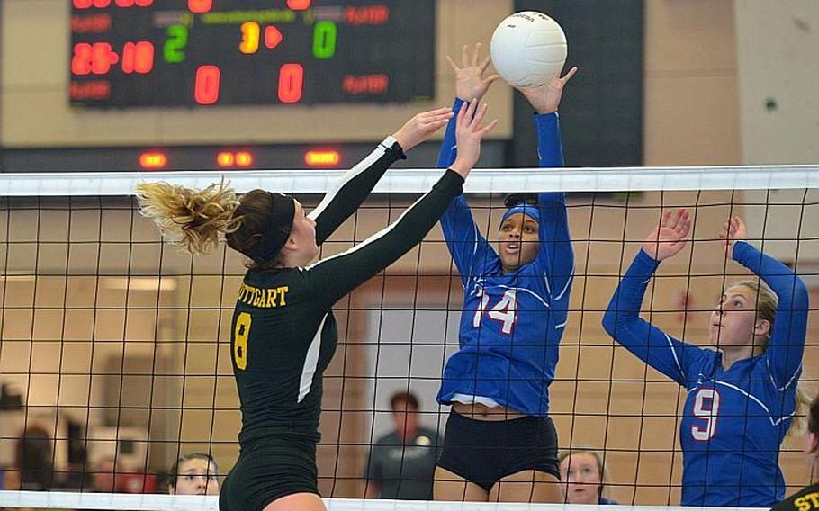 Stuttgart's Carly Sharp gets the ball love the net past Ramstein's Shemilia Johnson, left, and Paige Nielsen in the Division I final at the DODEA-Europe volleyball championships in Kaiserslautern, Germany. Stuttgart won  25-23, 25-18, 25-10.