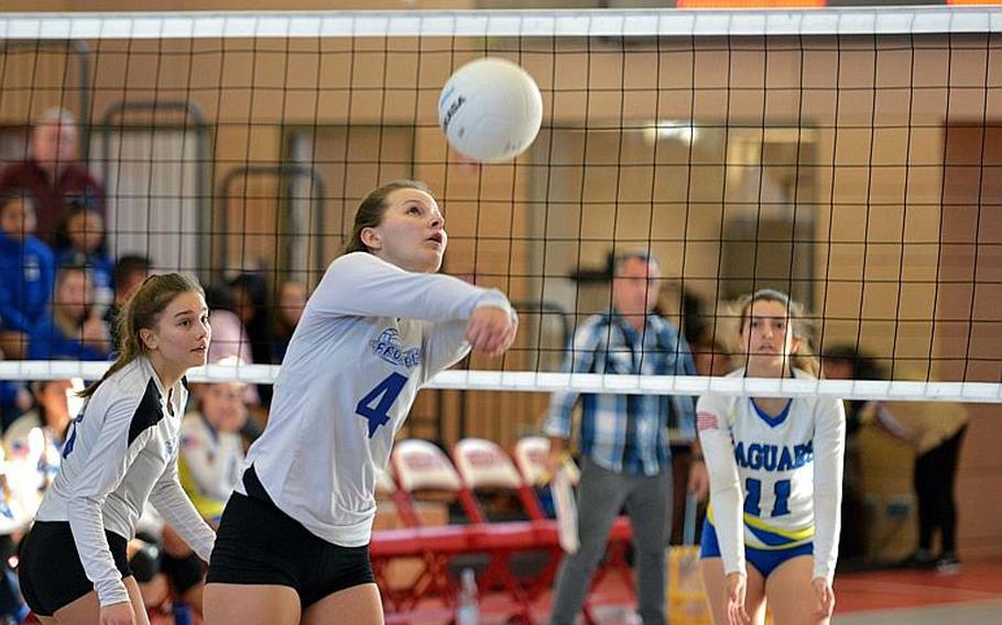 Olivia Friedhoff of Brussels returns a ball as Sigonella's Alex Garcia guards across the net in the Division III final of the DODEA-Europe volleyball championships in Kaiserslautern, Germany, Saturday, Nov. 3, 2018. Sigonella took the title with a 25-14, 25-13, 23-25, 25-17