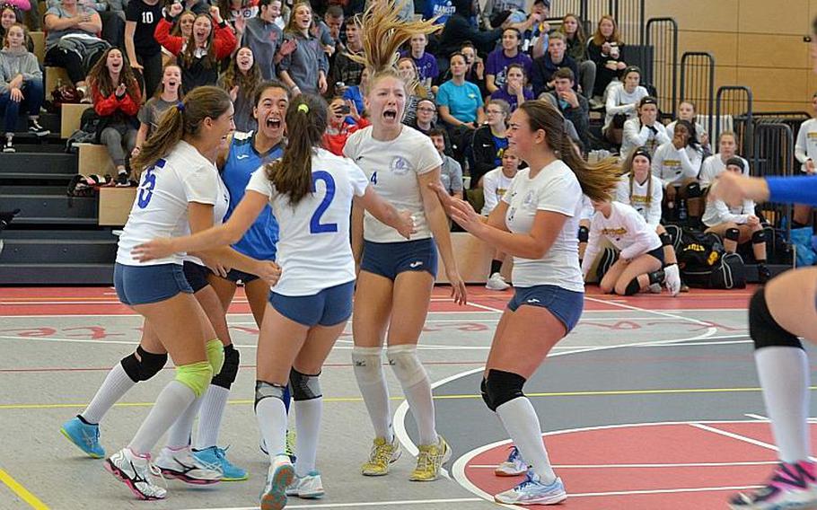 Marymount players celebrate their 24-26, 25-18, 25-21, 25-13 win over Black Forest Academy at the DODEA-Europe volleyball championships in Kaiserslautern, Germany, Saturday, Nov. 3, 2018.