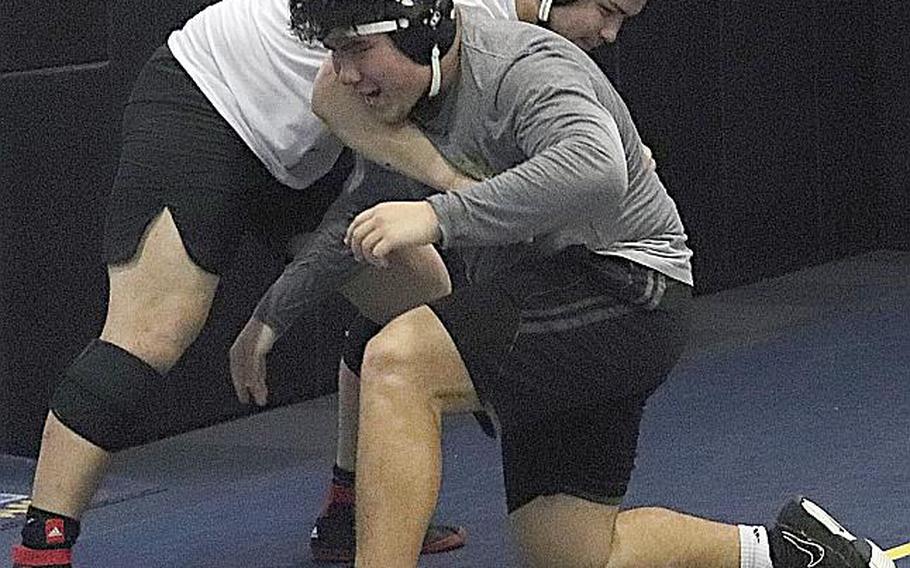 Senior Chris Mason, dark shirt and shorts, is one of five returning Far East wrestling tournament champions. He won the 215-pound class last year for Division I champion Nile C. Kinnick.