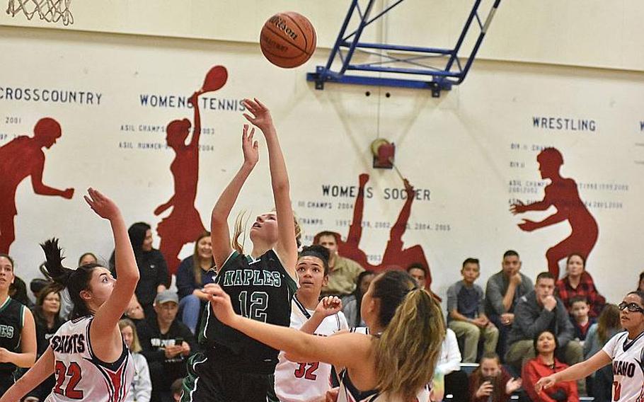 Naples' Roxanne Sasse gets up a shot and scores while surrounded by Aviano defenders in the Wildcats' 58-29 victory over the Saints on Friday, Feb. 1, 2019. Sasse had a game-high 23 points.