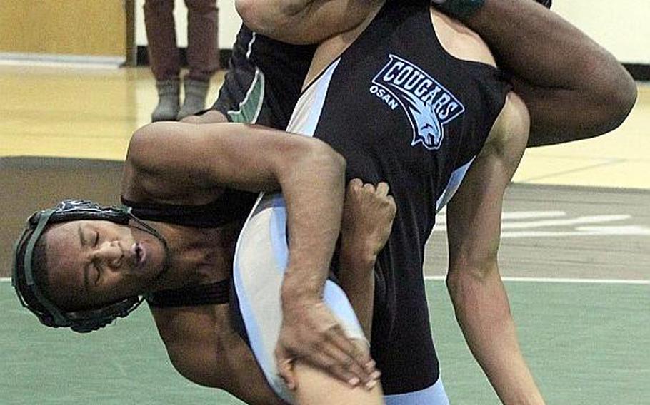 Osan's Marcus Inthavixay lifts Daegu's Gavin Jackson in the 158-pound bout during a DODEA-Korea wrestling quad meet at Camp Walke rin January. Inthavixay won a 12-9 decision and has gone unbeaten against Jackson this season.