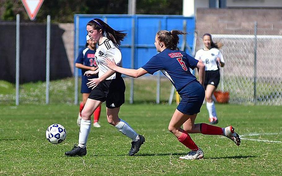 Liv Sullens, a forward for the Stuttgart Panthers, drives past Aviano defenders during Saturday???s game that was played at the Aviano stadium. Sullens scored three times in the game, which the Panthers won easily 7-0.