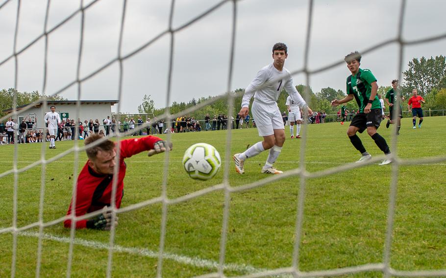 Naples' Matthew Alindog, right, watch as his shot goes in the goal during a game against Vilseck on the first day of the DODEA-Europe soccer championships, Monday, May 20, 2019.