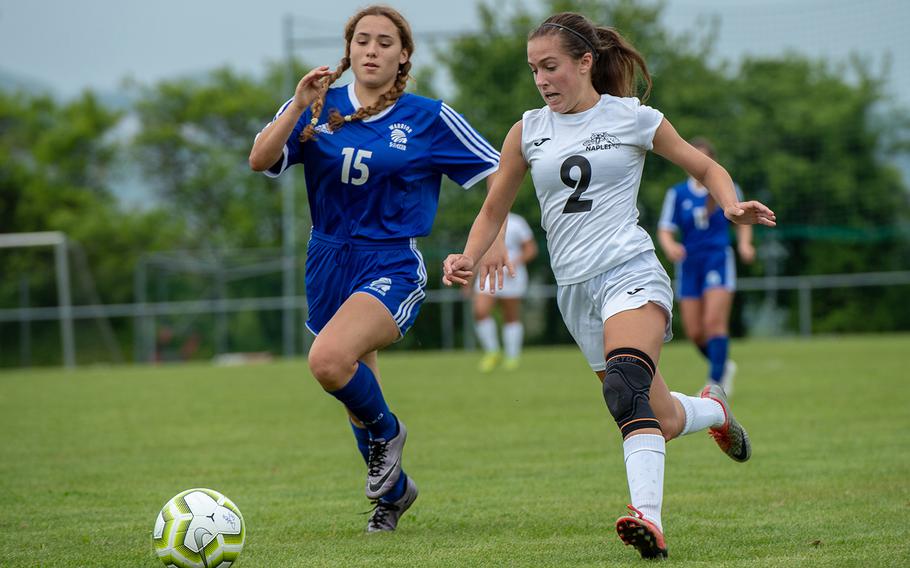 Naples' Abigail Houseworth, right, and Wiesbaden's Livia Baker-McKee chase down the ball during the first day of the DODEA-Europe soccer championships, Monday, May 20, 2019.