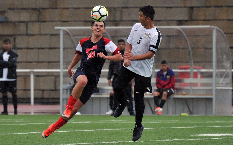 Aviano's Logan Hinchcliff knees the ball over Bahrain defender Joseph Camuso in a Division II game in Kaiserslautern, Tuesday, May 21, 2019. The game ended in a 1-1 tie.